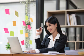 Business woman using calculator for do math finance on wooden desk in office and business working background, tax, accounting, statistics and analytic research concept.