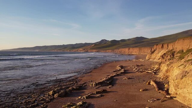 2023 - Excellent aerial footage pulling away from waves lapping the rocky shores of Jalama Beach, California.