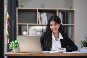 Business woman using calculator for do math finance on wooden desk in office and business working background, tax, accounting, statistics and analytic research concept.