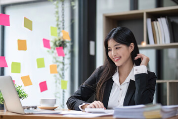 Business woman using calculator for do math finance on wooden desk in office and business working background, tax, accounting, statistics and analytic research concept.