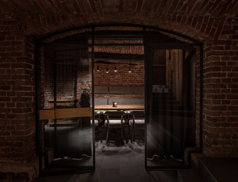 Illuminated restaurant in loft style with shabby brick walls