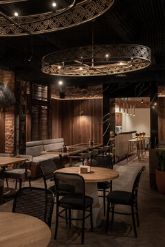 Illuminated restaurant in loft style with shabby brick walls