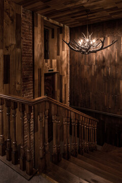 Illuminated restaurant in loft style with shabby wood walls