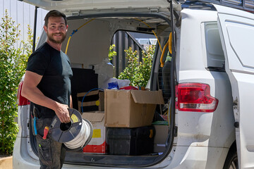Electrician loading his work van