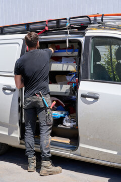 Electrician taking cabling from his work van