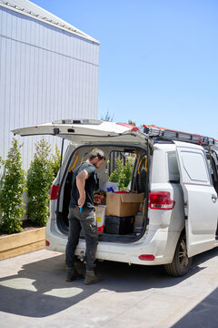 Electrician with his work van loaded with equipment