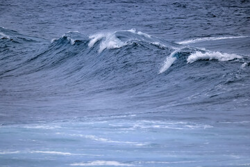 Fototapeta premium wave in the ocean abstract background, blue sea texture motion