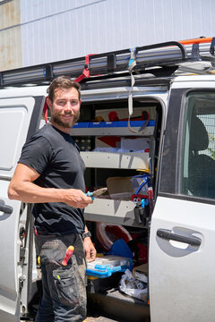 Electrician with work tool and van