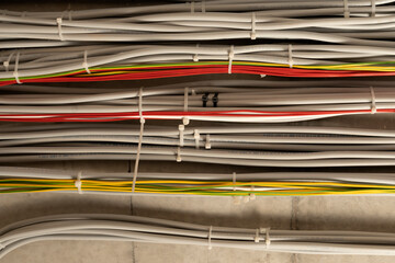 Large group of UTP cables, Ethernet cables in rack cabinet, UTP cables from a patch panel in the server rack in the data center room.