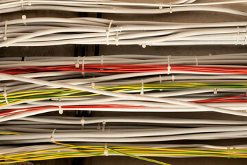 Large group of UTP cables, Ethernet cables in rack cabinet, UTP cables from a patch panel in the server rack in the data center room.