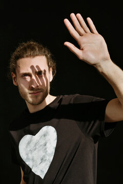 Modern man shields face from sun.