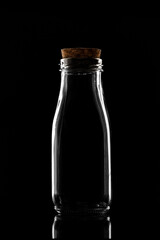 Empty milk Bottle on black background 