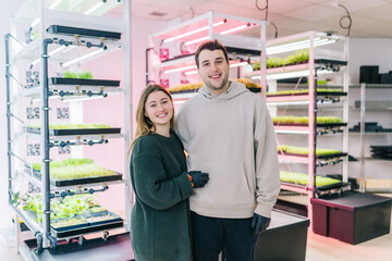 Happy couple hugging and smiling in plant nursery