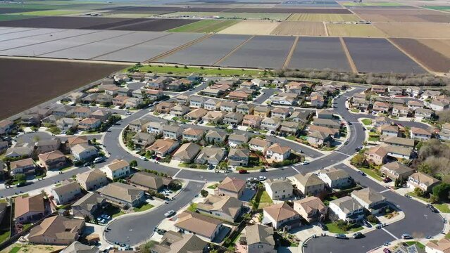 2023 - Excellent aerial footage of a neighborhood next to farmland in Lompoc, California.