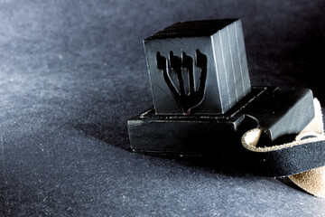 Jewish ritual objects, prayer vestments, Tefillin on dark background