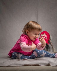 Portrait of a beautiful little girl with a dog in the studio.