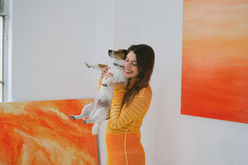 Portrait of Beautiful Female Painter Holding Her Dog