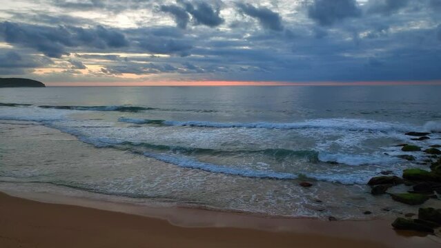 Sunrise seascape with colour and clouds at Killcare Beach on the Central Coast, NSW, Australia.