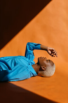 Black woman lying with hand over face