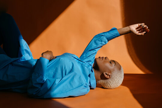 Black woman lying on floor in studio