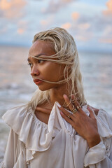 Obraz premium Portrait of woman in dress on bali beach
