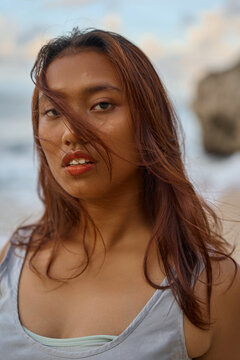 sensual beautiful plus size asian woman in dress on bali beach