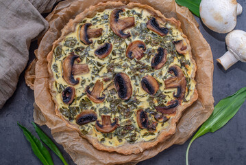 home made quiche with wild garlic on a table