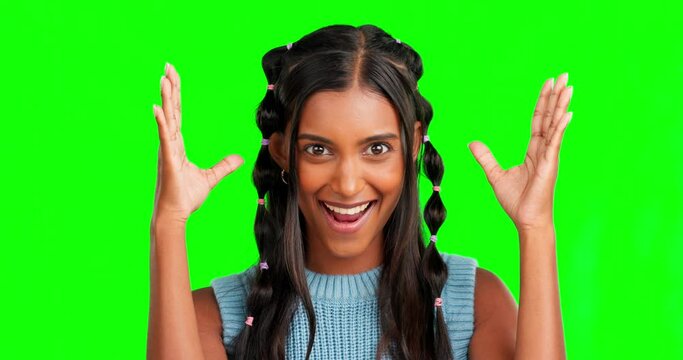 Woman, mind blown and face in green screen studio with surprise, wow and hands in air for mock up. Young indian student, amazed girl and shock in mockup portrait by background with gen z fashion