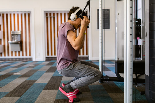 Teen boy exercising At Fit Gym