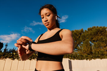 Sportswoman checking smart watch