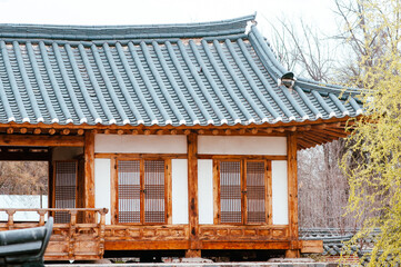 Beautiful rooftop oriental house at traditional korean garden. Scenery of Korean countryside with ancient architectural features of roof stile at buddhist temple