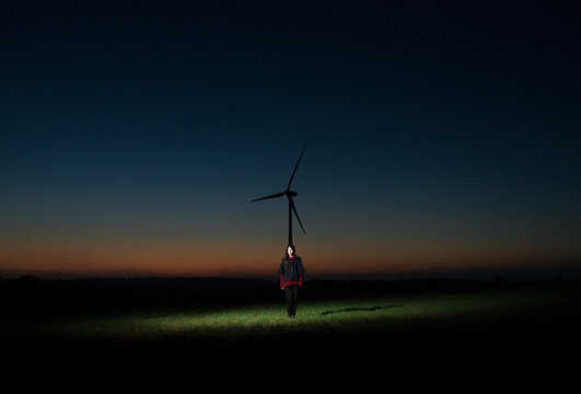 Surreal scenery with standing woman and windmill