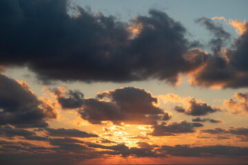 dramatic orange and dark blue cloudy sky at sunset