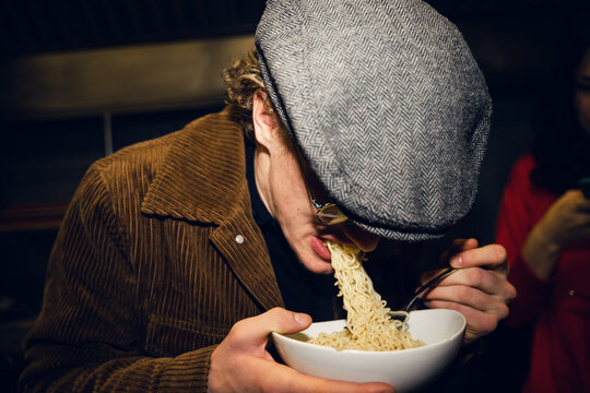 UGC young man with beret eating noodles