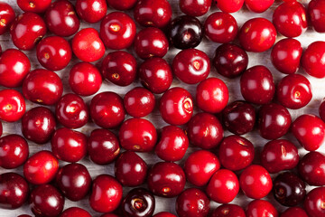 Raw organic cherries on wooden table in close up photo
