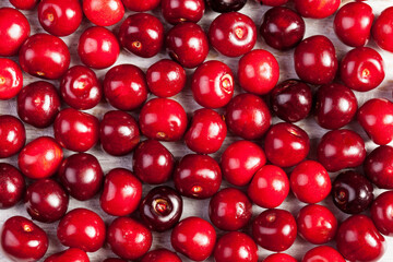 Bunch of cherries on wooden table in close up photo. Summer freshness