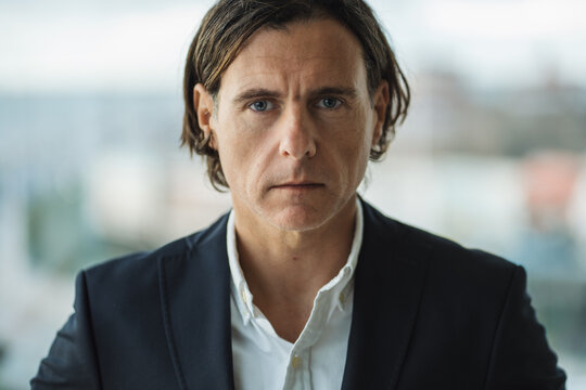 Serious middle age businessman looking at camera