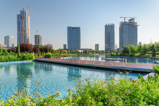 Contemporary buildings reflected in pool of Tashkent City Park