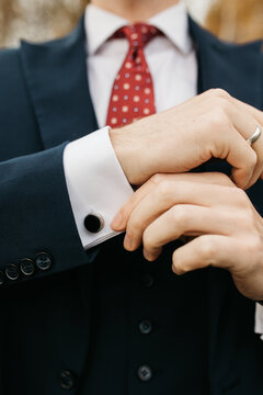 Close-up photo of a man in suite showing cuff