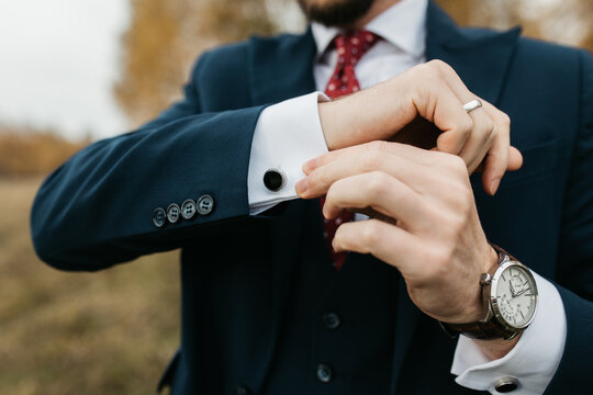 Close-up photo of a man in suite showing cuff