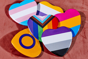 badges patterned with different LGBTIQ flags