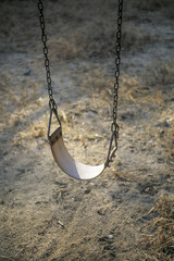 Lonely old swing in the sunset, blurred background, selective focus