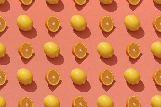 Ripe lemons and halves on red background, top view