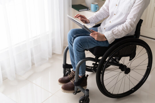 Person With Disability Using Tablet At Home