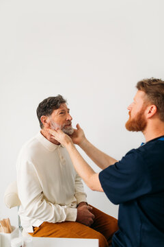 Doctor Examining Senior Man 