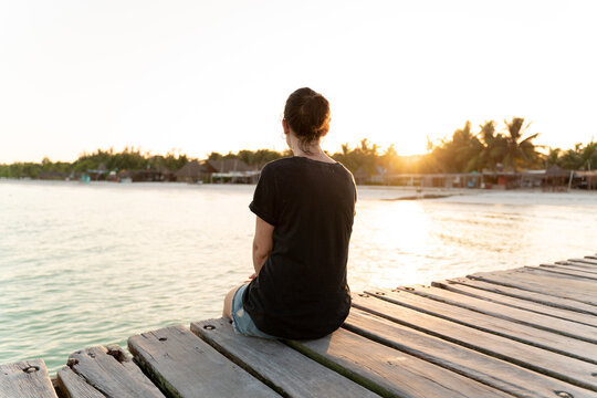 Woman by the sea at sunrise, Mexico