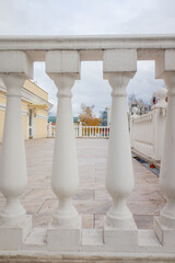 Row of white concrete balusters on the embankment close-up