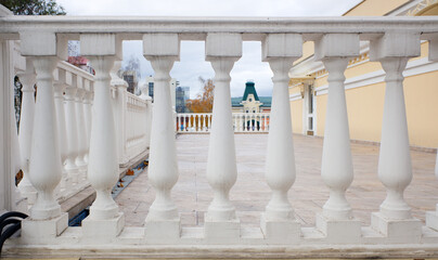 Row of white concrete balusters on the embankment close-up - obrazy, fototapety, plakaty