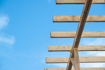 wooden planks are white against the blue sky.