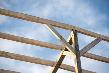 wooden planks are white against the blue sky.